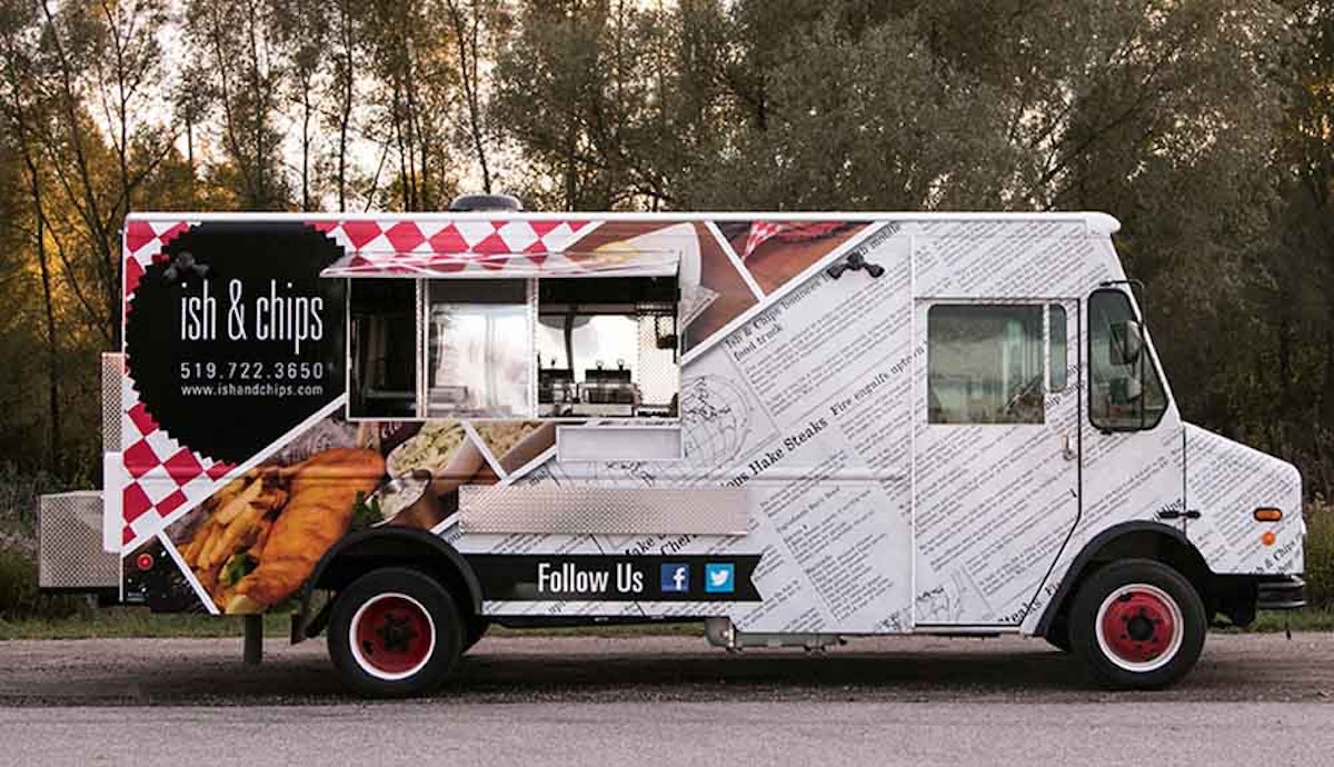 A food truck with a side view of a food truck.