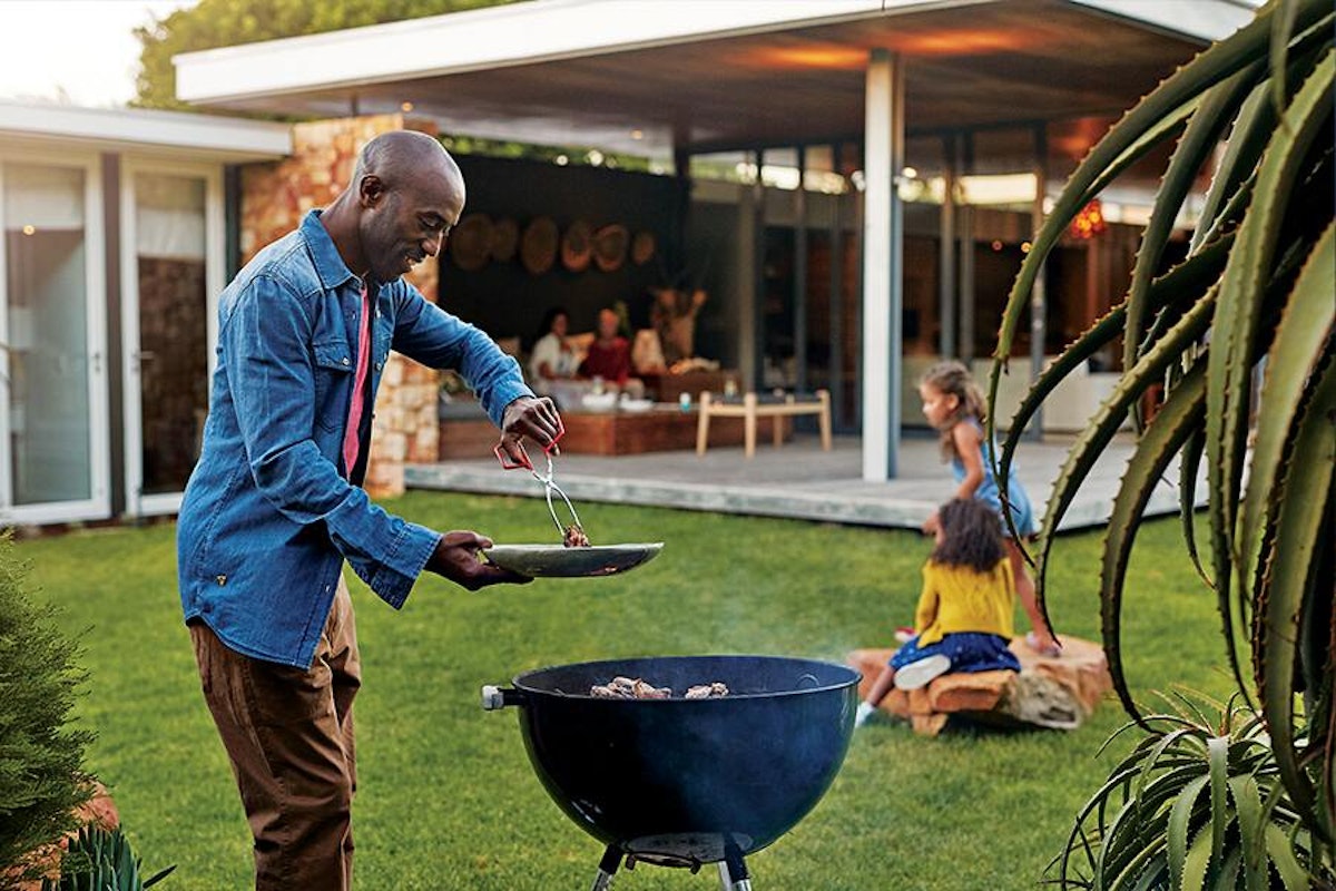 A man cooking on a bbq grill.
