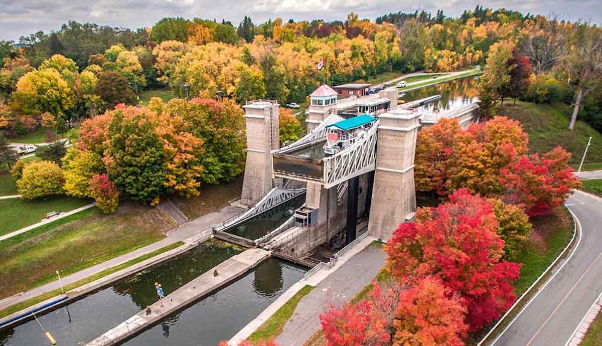 An aerial view of a lock with trees surrounding it.