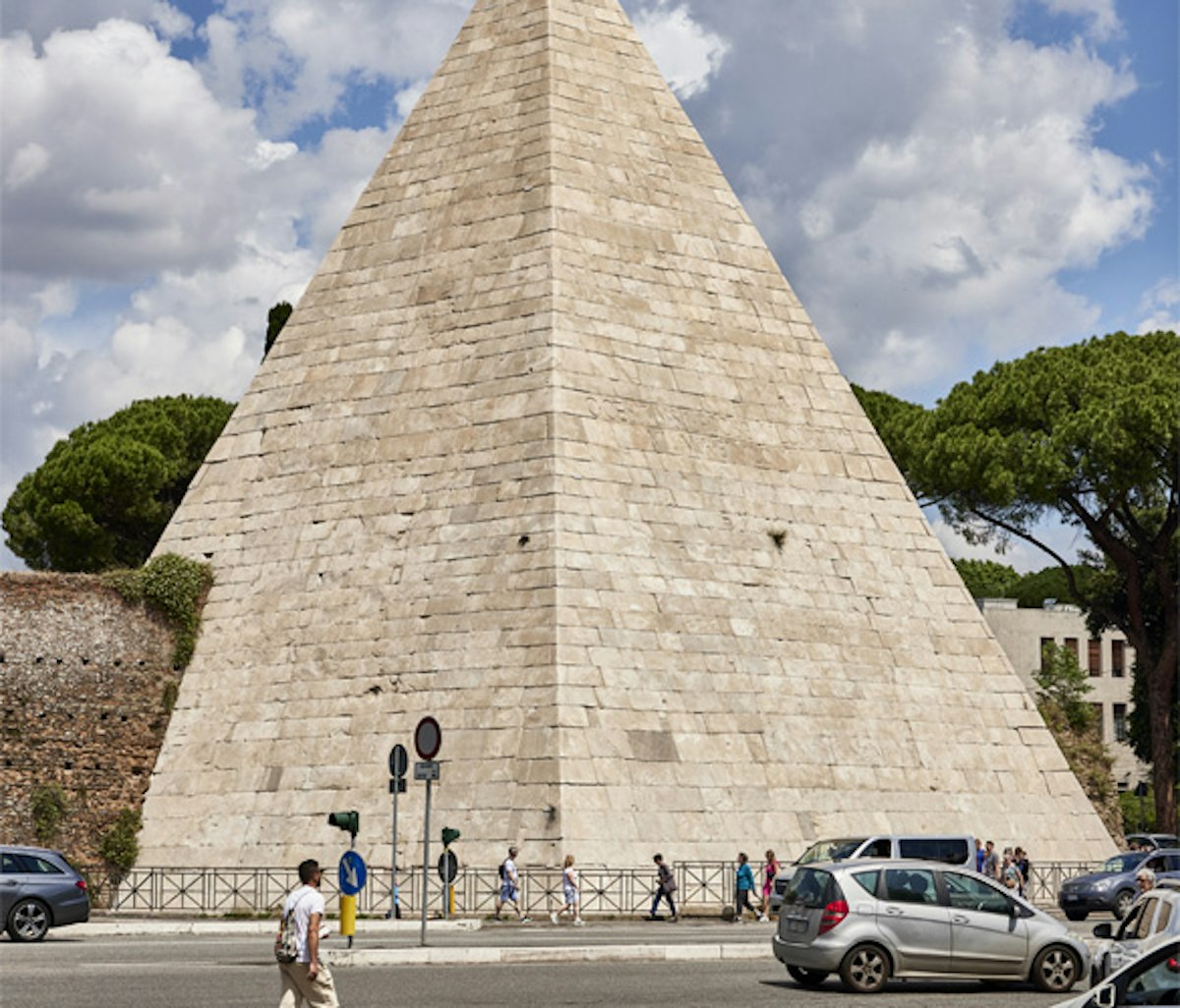 A large pyramid in the middle of a street.