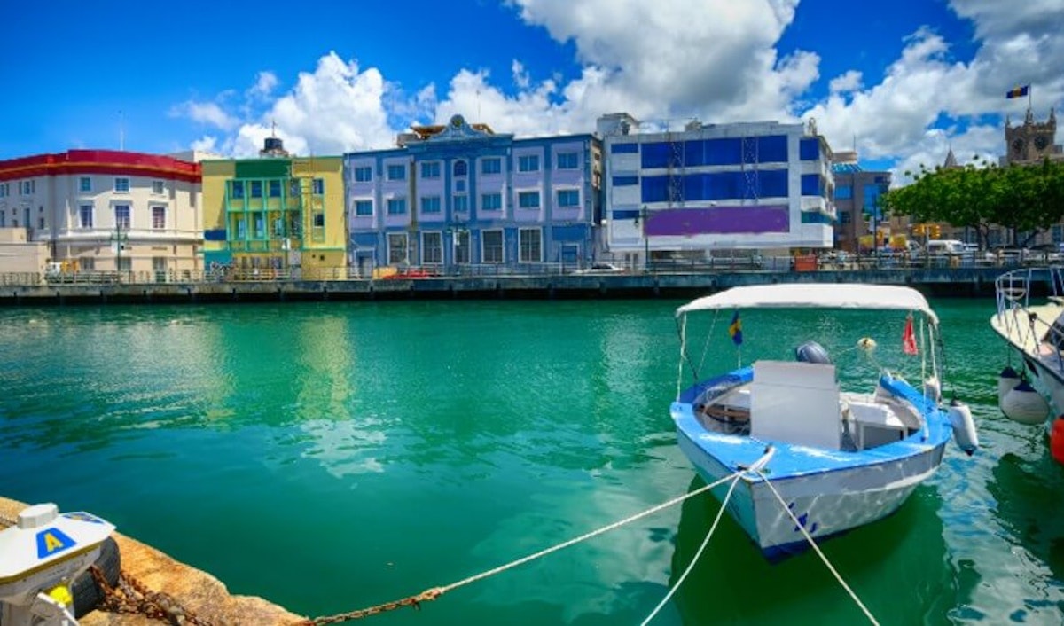 A boat docked in front of colorful buildings.
