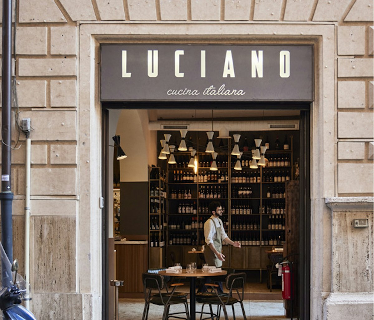 The entrance to a restaurant with a sign that says lucano.
