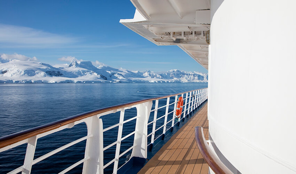 View from a cruise ship deck overlooking icy antarctic waters.