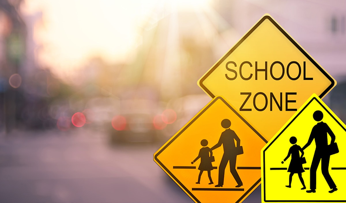 School zone signs on a city street.