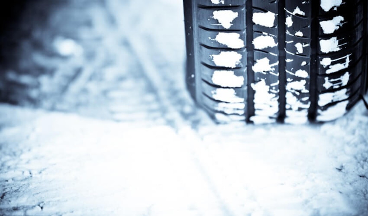 A close up of a tire with snow on it.