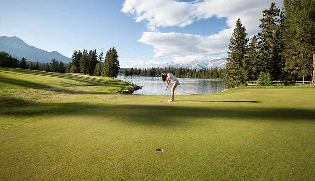 A woman playing golf on a golf course.