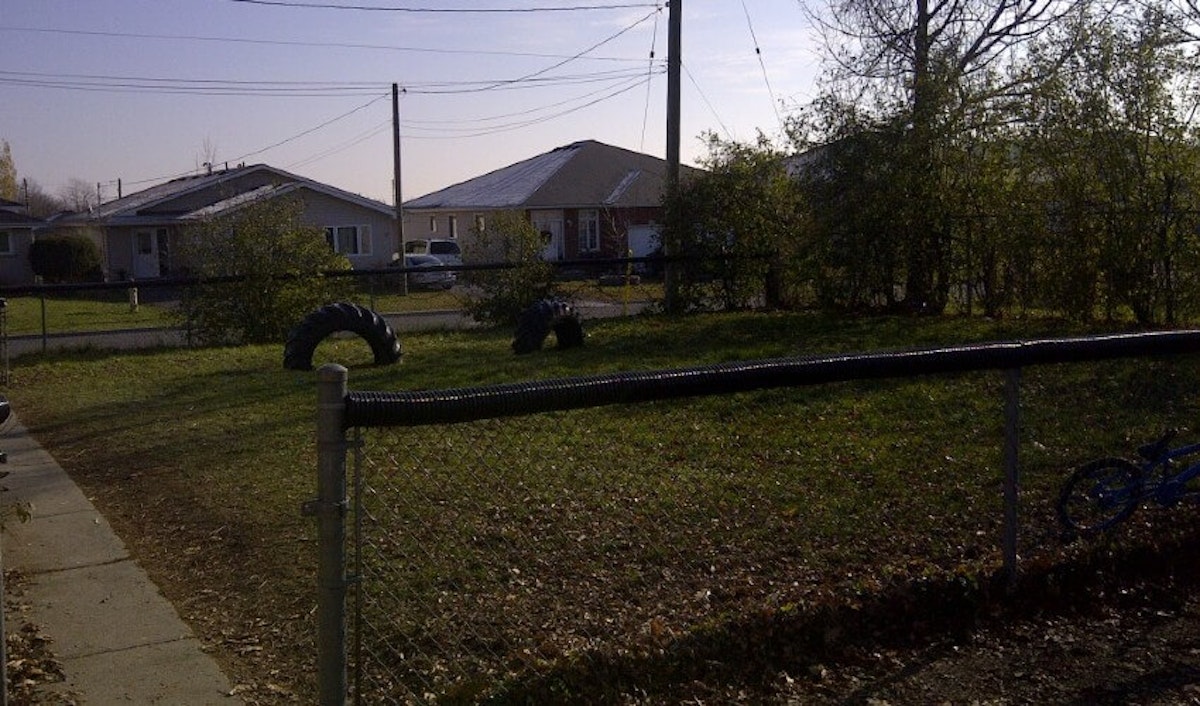 A fenced in yard with tires.