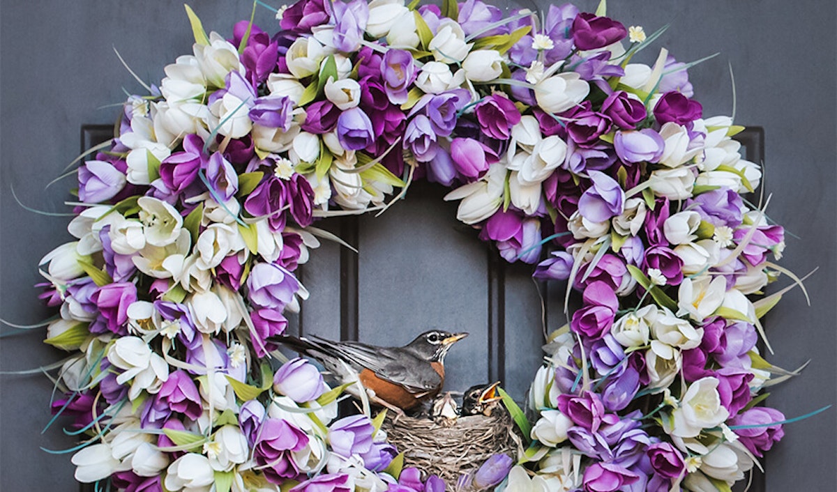 A purple and white wreath with a bird on it.
