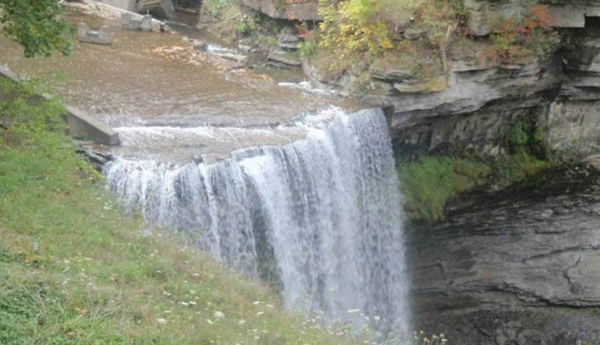 A waterfall in the middle of a cliff.