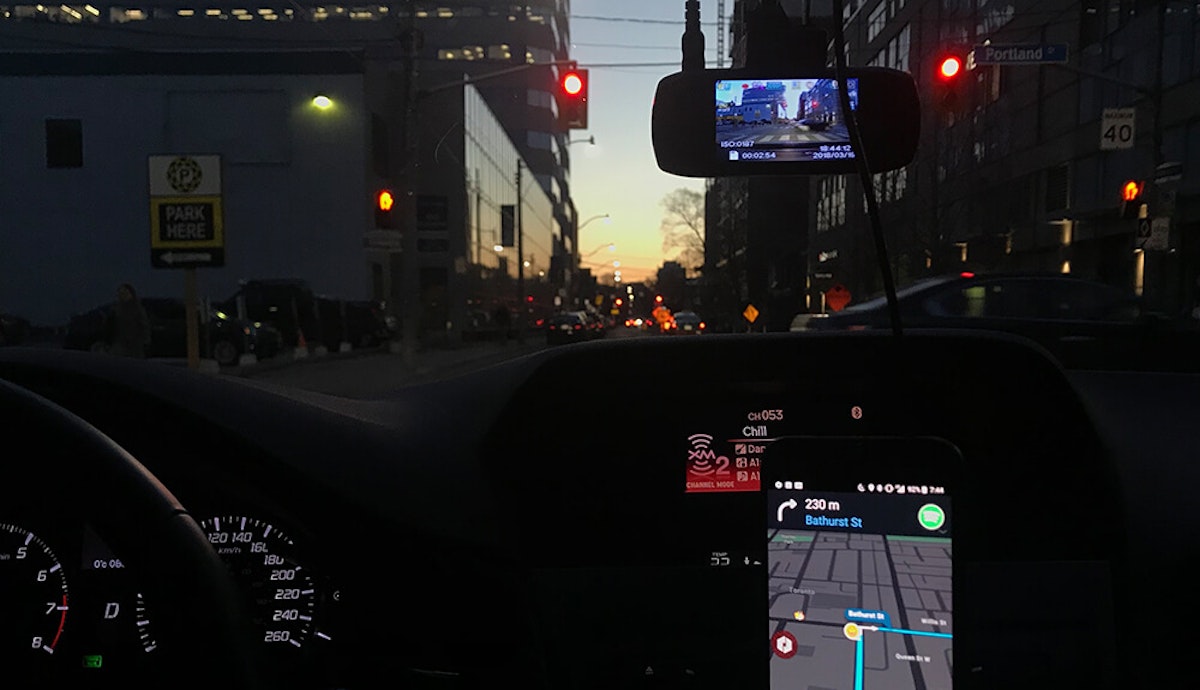 The dashboard of a car with a gps device on it.