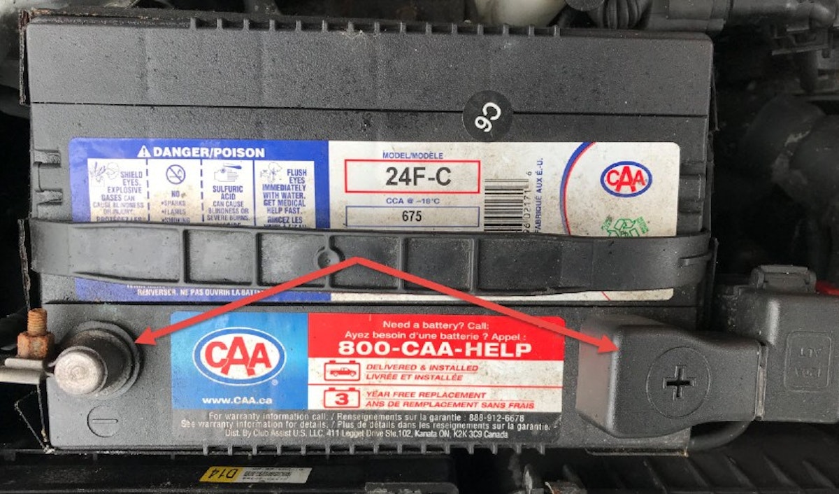 A car battery with a sticker on it.