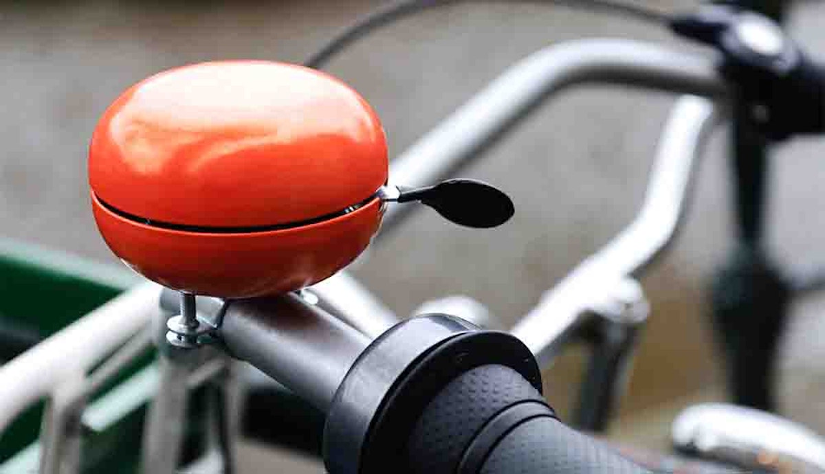A bicycle with a red ball on the handlebar.