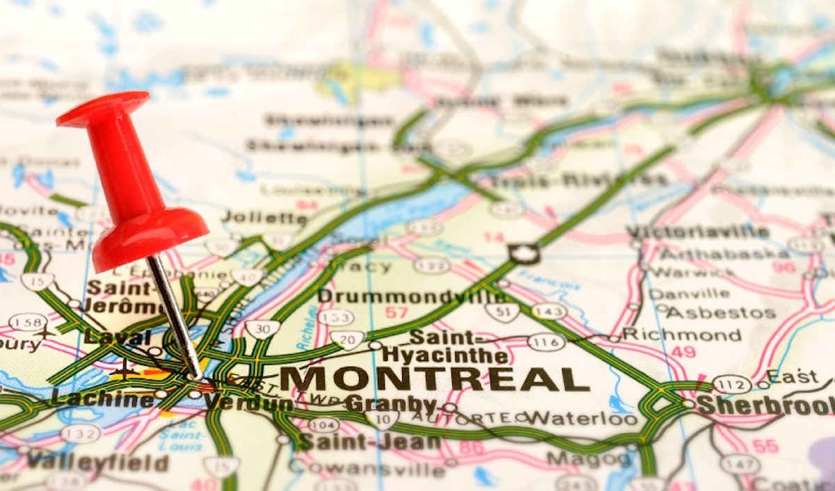 A red pin pointing montreal on a map.