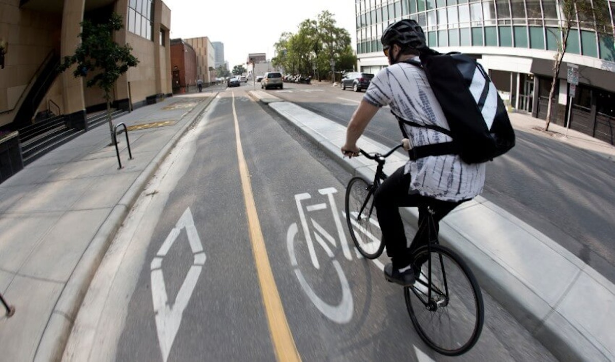 A man riding a bike on a city street.