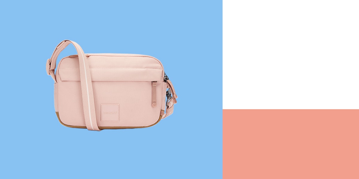 A pink cross body bag on a blue and white background.