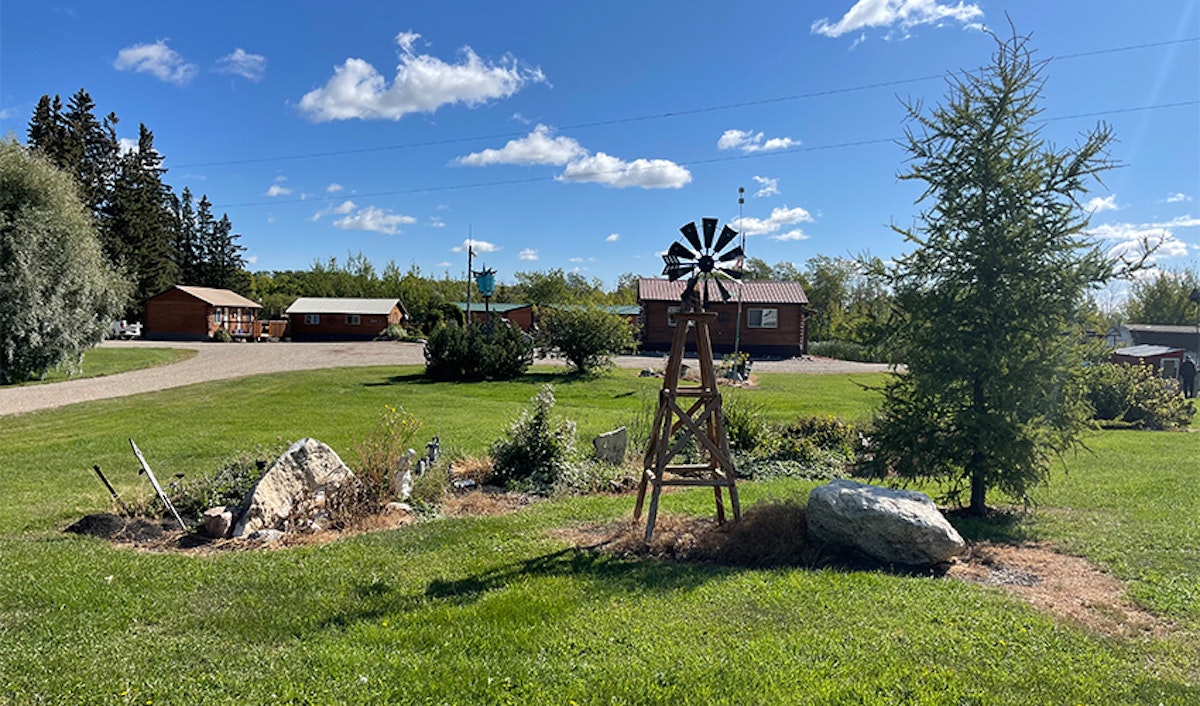 A windmill in a yard.