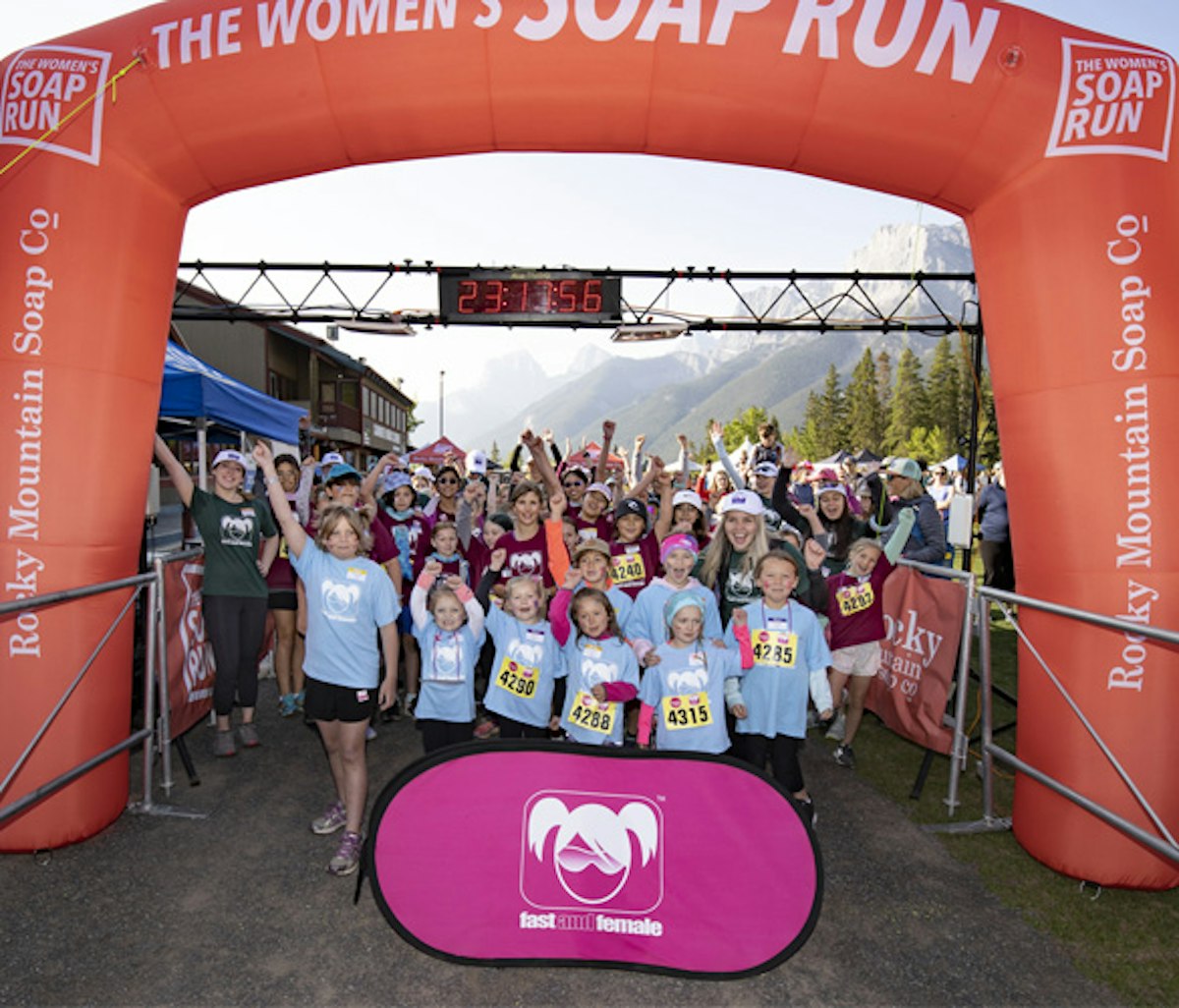 A group of participants celebrating at the finish line of the women's soap run event.