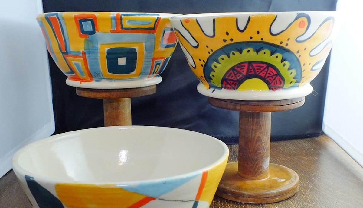 Three ceramic bowls with colorful designs on them.