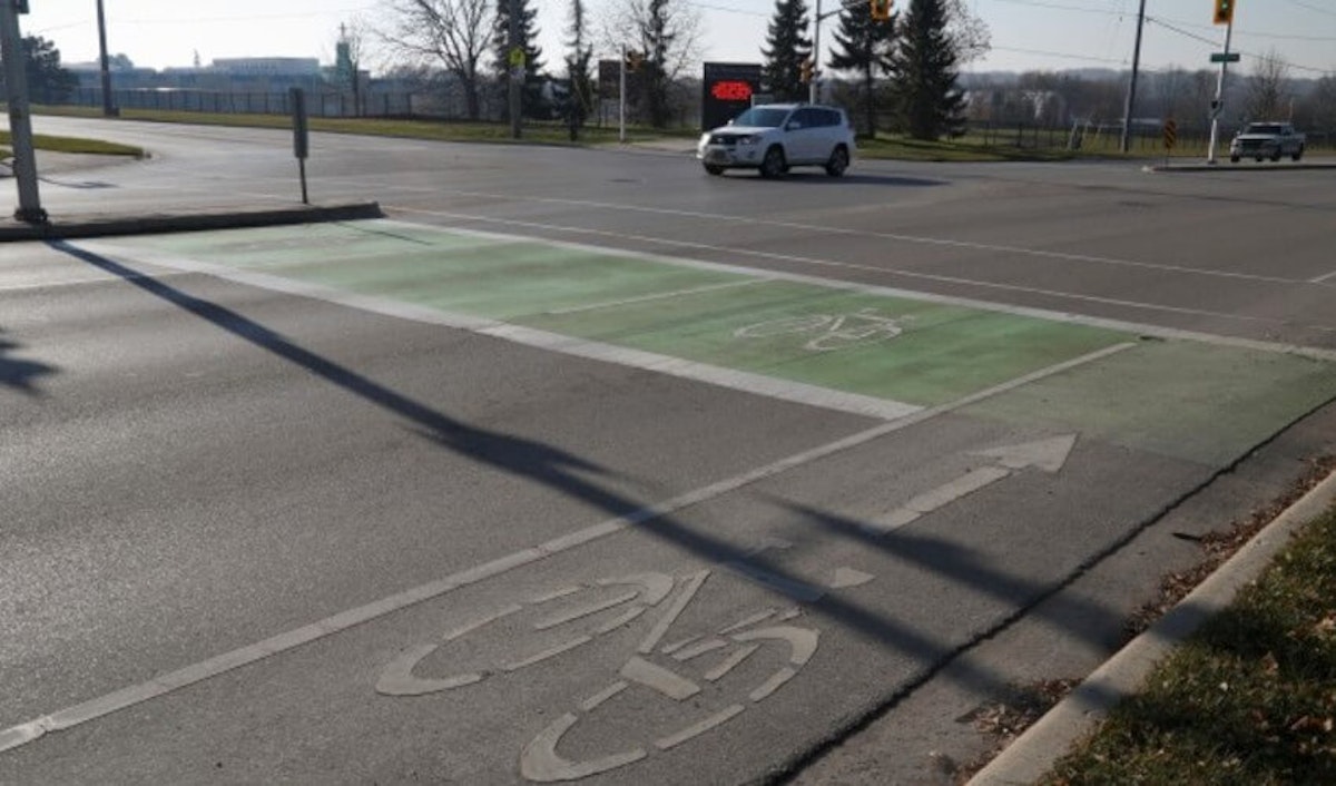 A bike lane is painted on the side of a street.