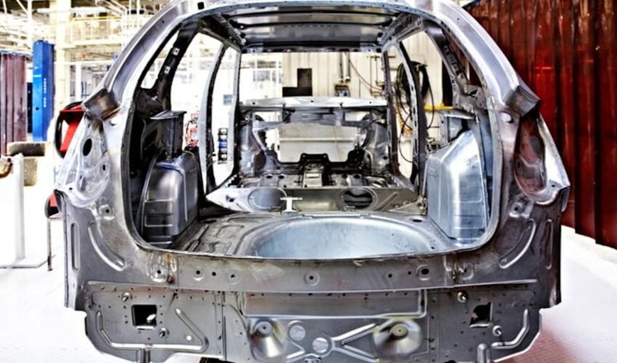 An image of a car being built in a factory.