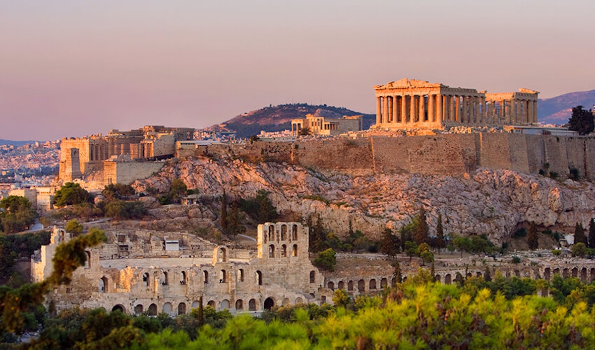 The acropolis of athens at sunset, featuring the parthenon and other ancient ruins.