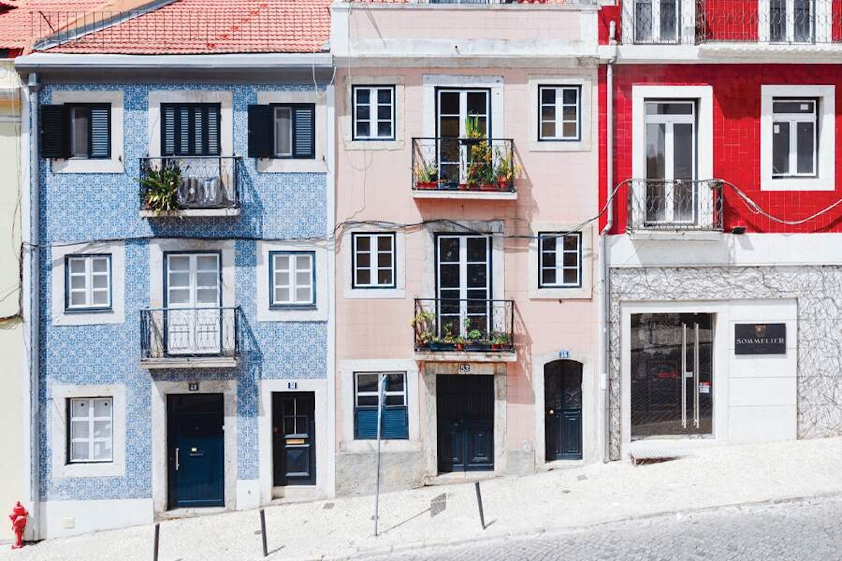 A row of colorful houses on a street in lisbon, portugal.