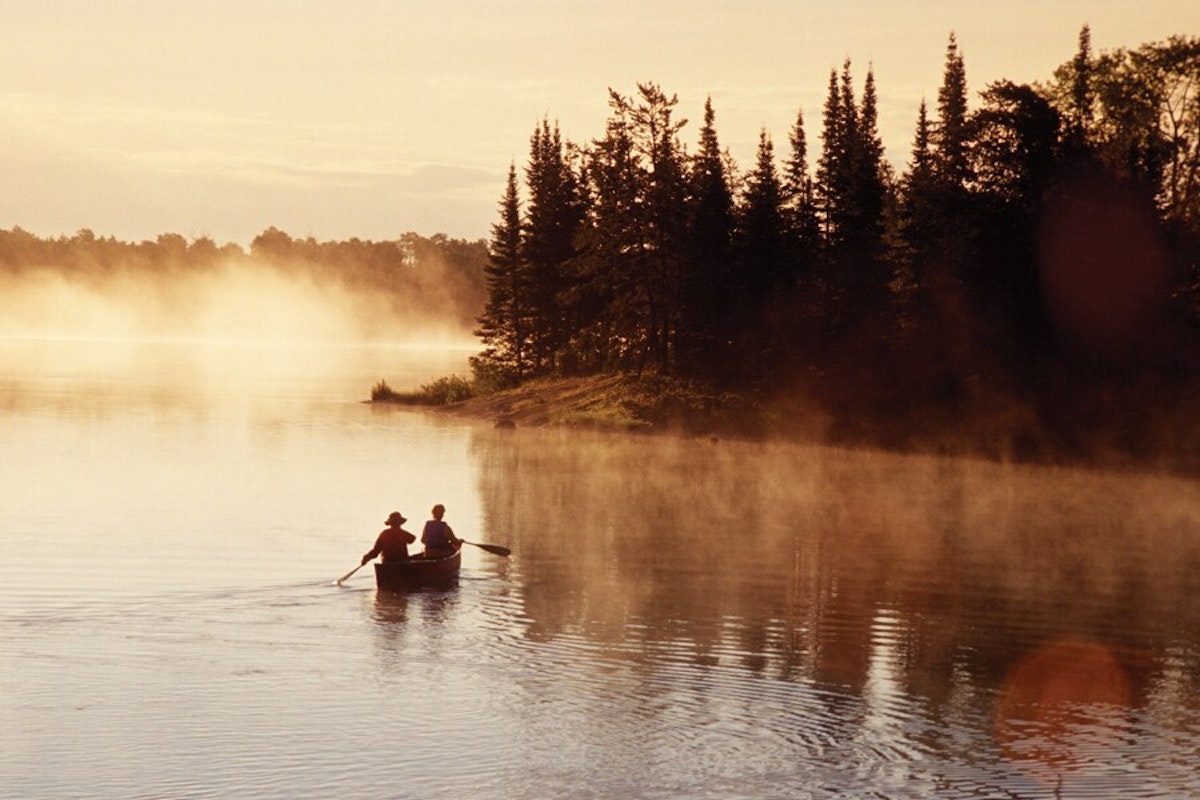 Two people in a canoe on a river.
