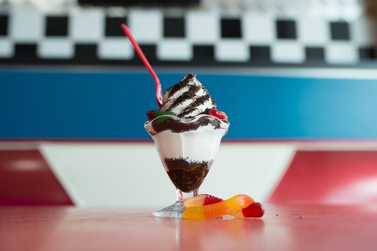 An ice cream sundae sitting on top of a table.