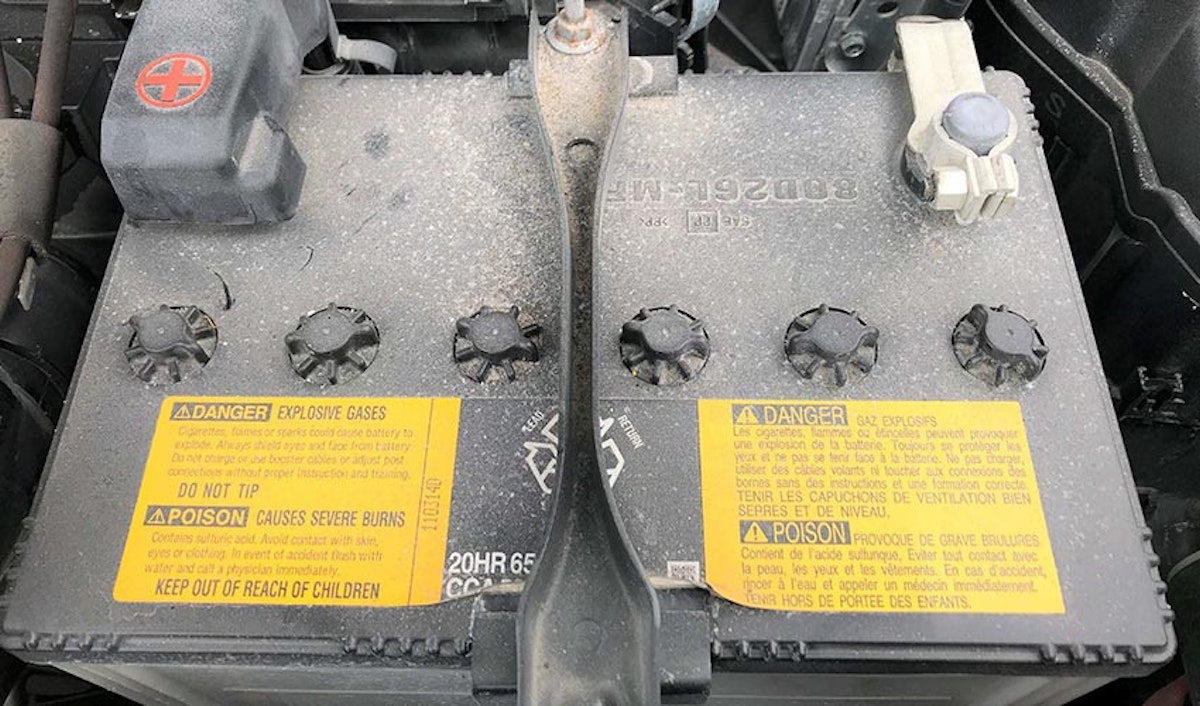 A picture of a car battery with a label on it.