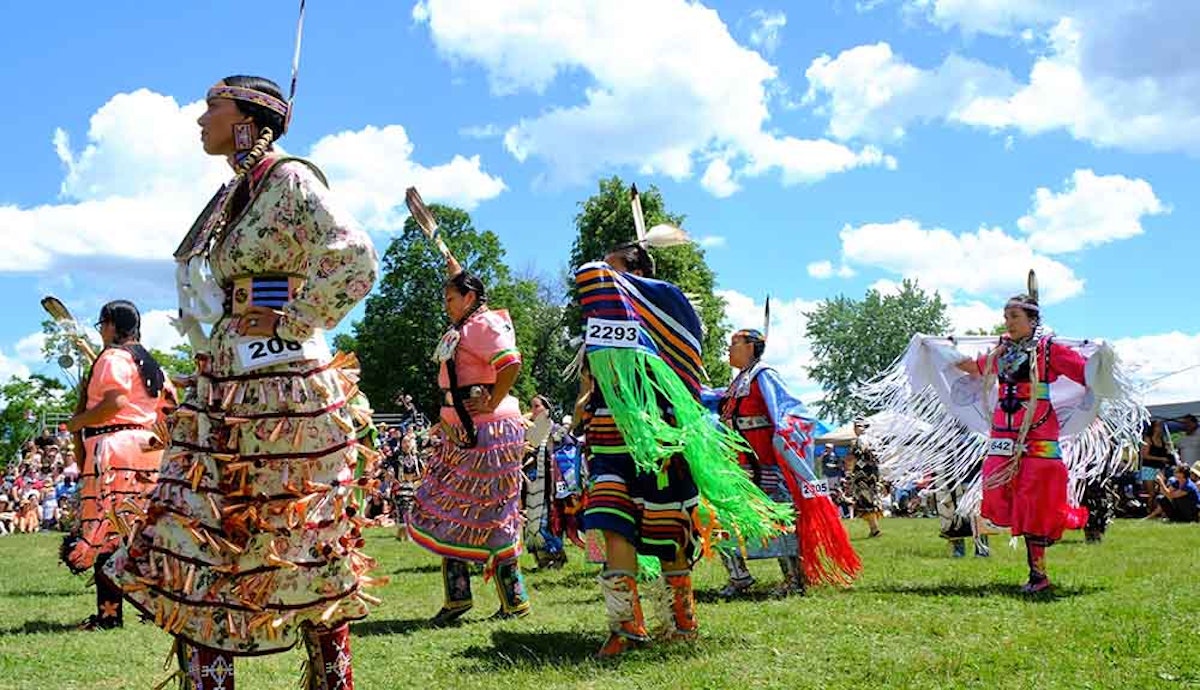 A group of native dancers perform at a festival.