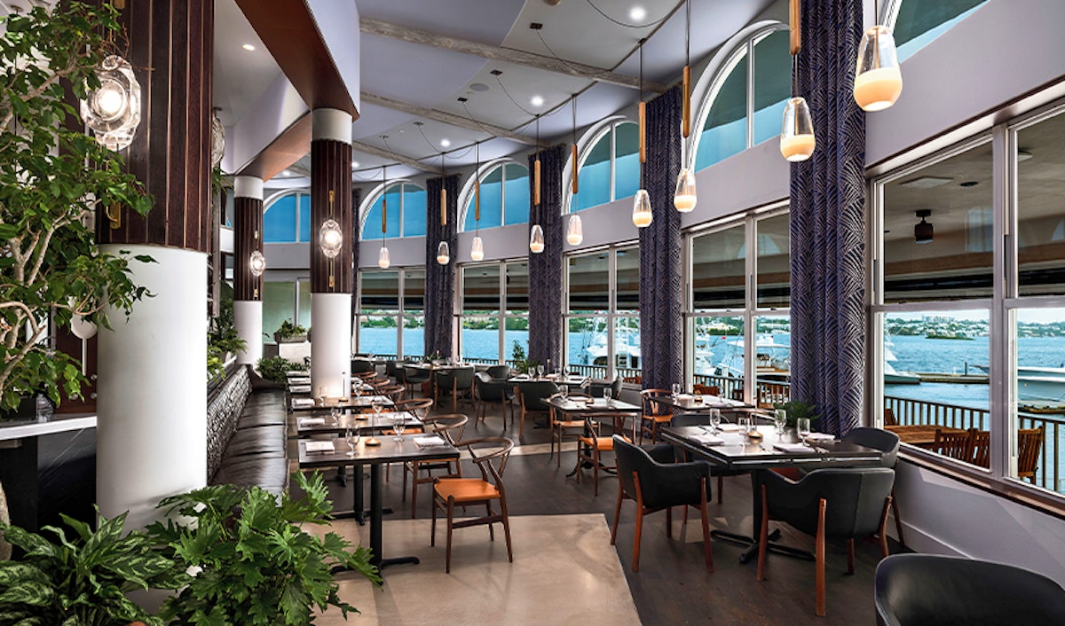 Modern restaurant interior with stylish décor and waterfront view.