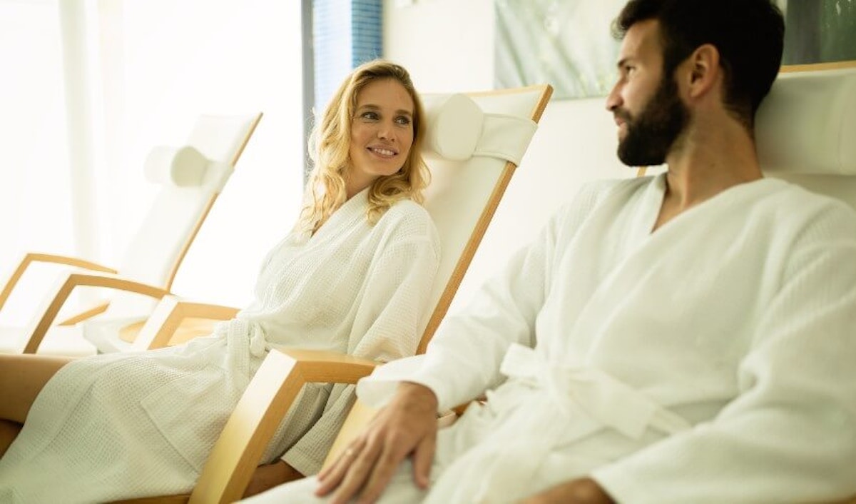 A man and woman sitting in chairs in a spa.