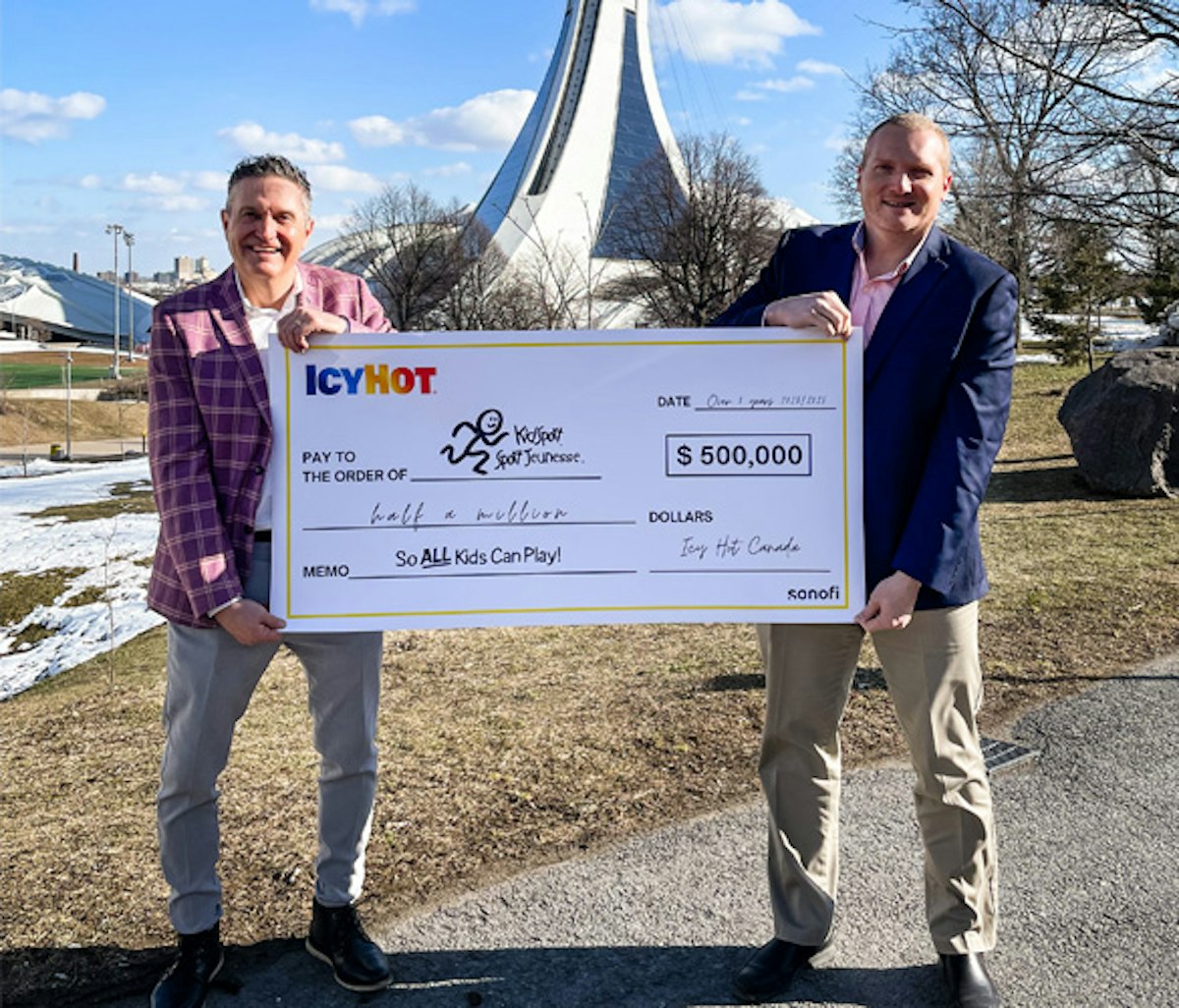Two individuals holding a large ceremonial check for a donation of $500,000 from icyhot to kidsport.