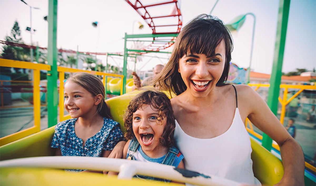 Family enjoying a ride at an amusement park.