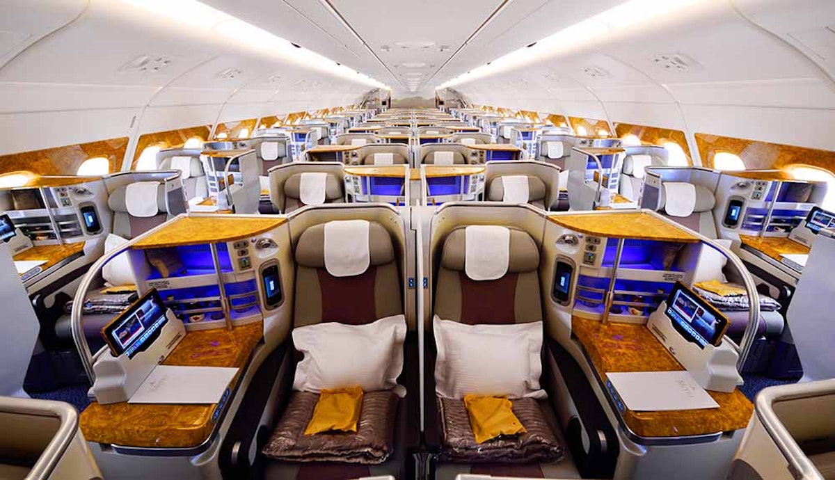 The interior of an airplane with many rows of seats.