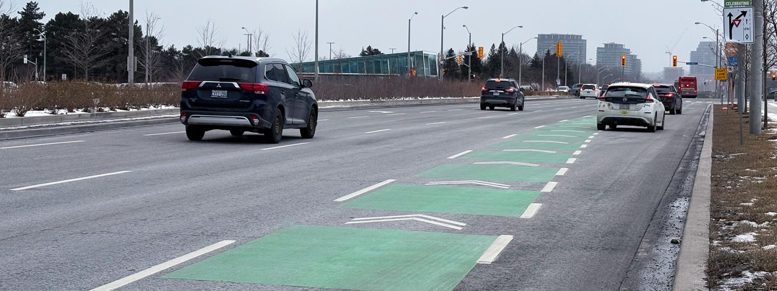 Toronto fixed street with traffic lights and a few cars.