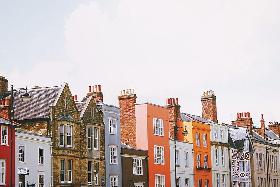A row of colorful buildings on a street.
