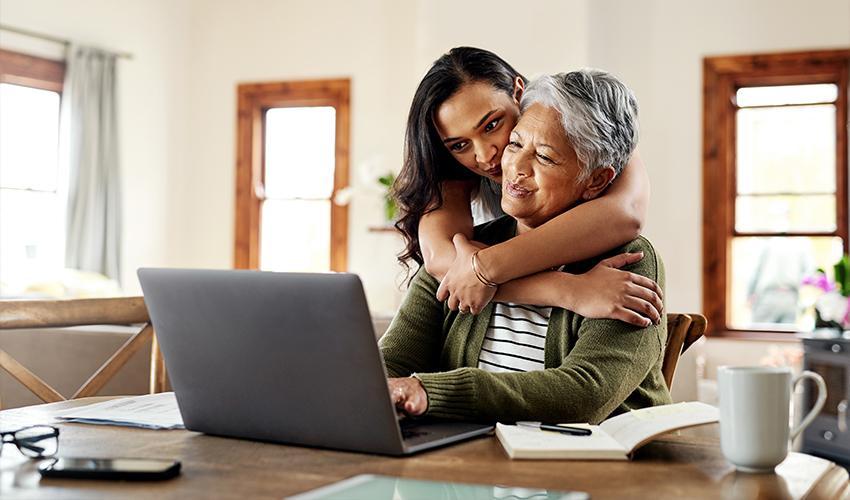A woman hugging an old woman.