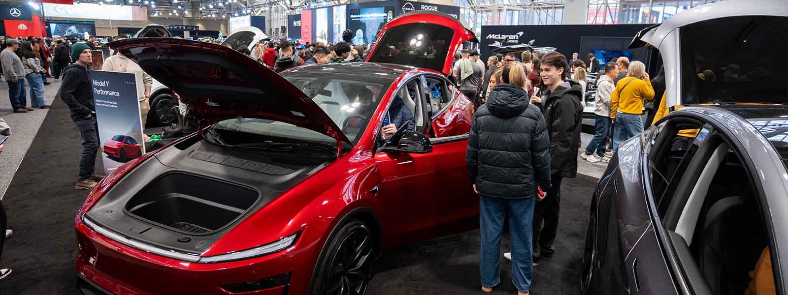 A red Tesla Model Y vehicle is on display in the middle of the 2026 Canadian International Auto.
