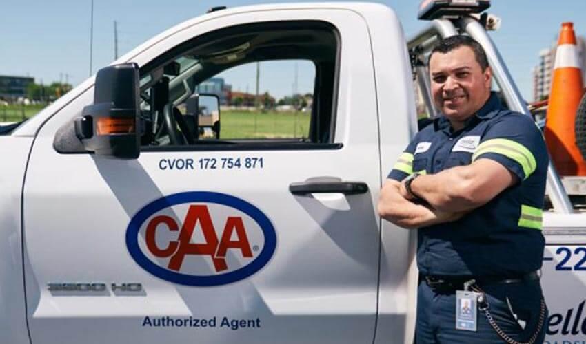 A man standing in front of a white truck.