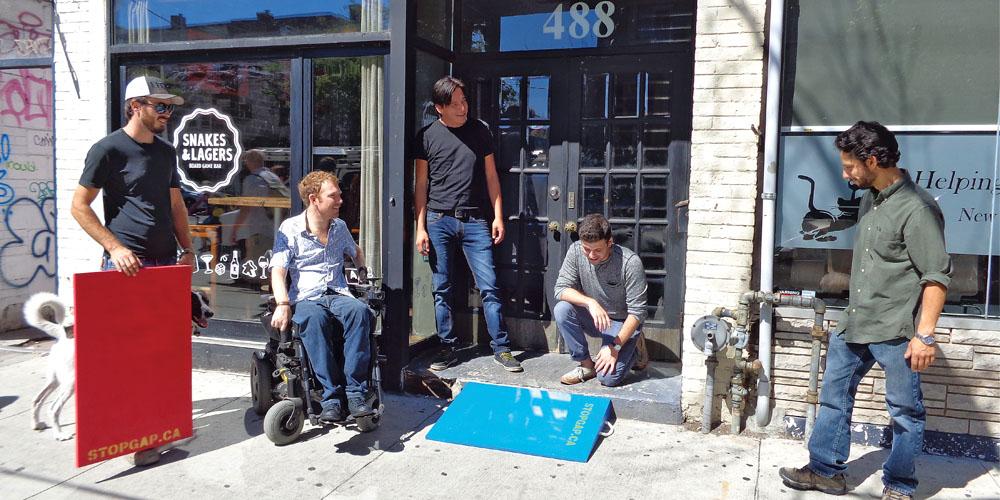 A group of people standing in front of a store.