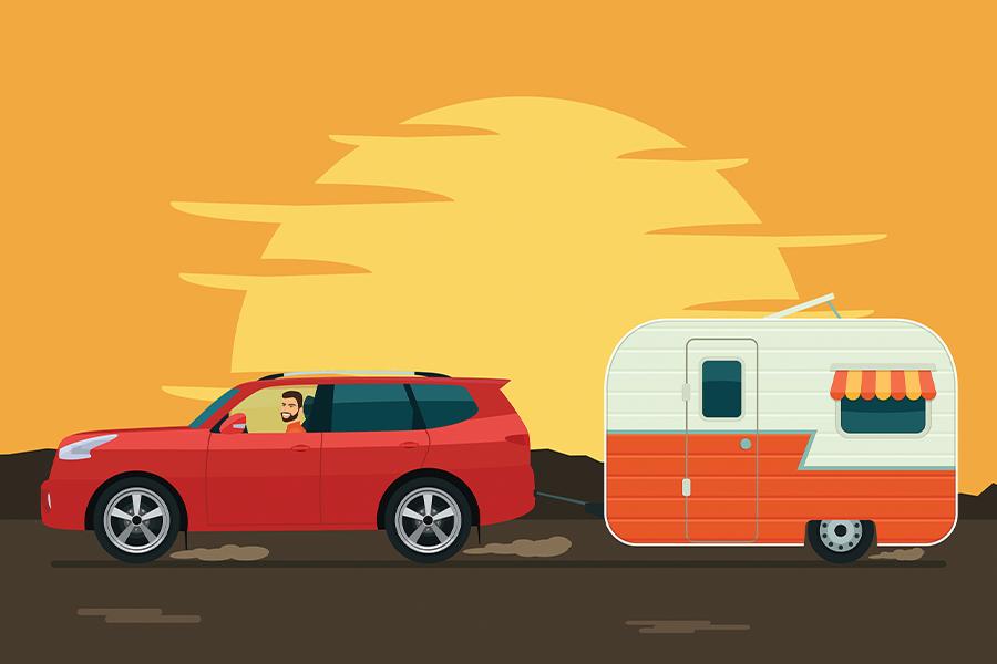 A dog is pulling a trailer with a car behind it.