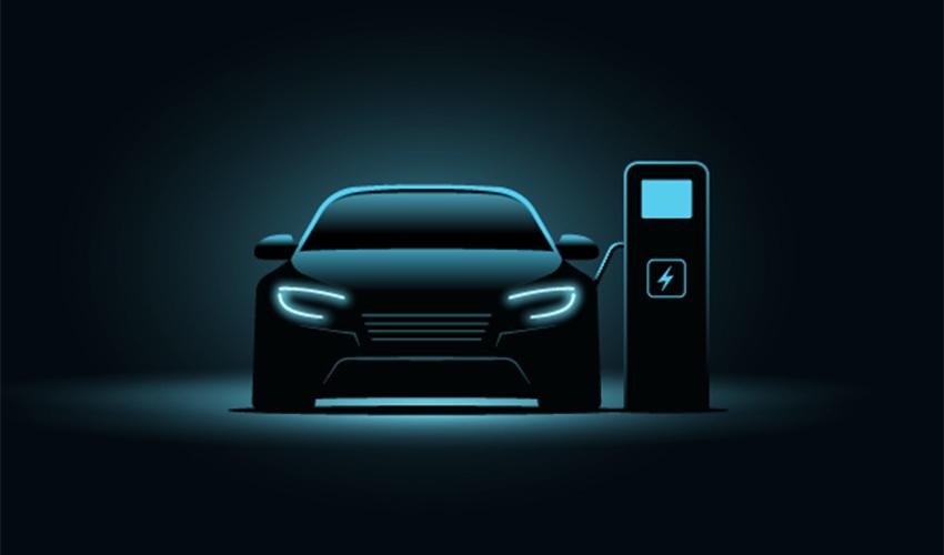 An electric car charging at a charging station on a dark background.