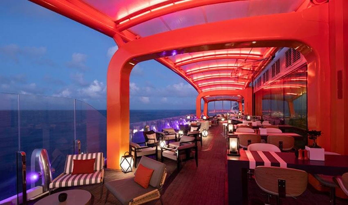 A restaurant on a cruise ship with a view of the ocean.