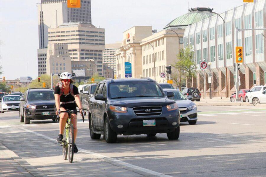 A woman riding a bike on a city street.