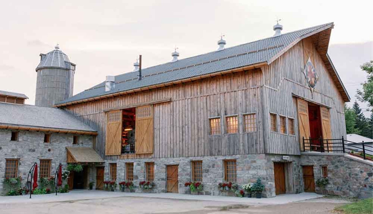 A barn with wooden doors and windows.