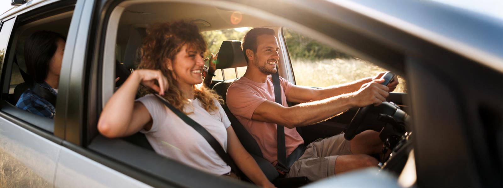 Group of people in a car driving photo through the open side window
