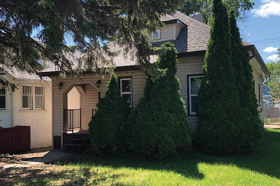 A house with trees in front of it.