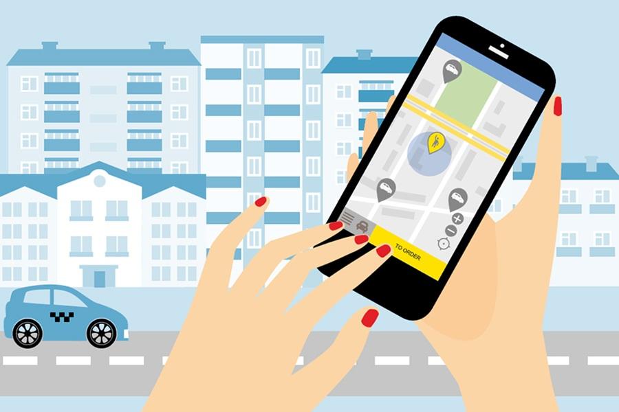 A woman's hand holding a smartphone with a gps app on it.