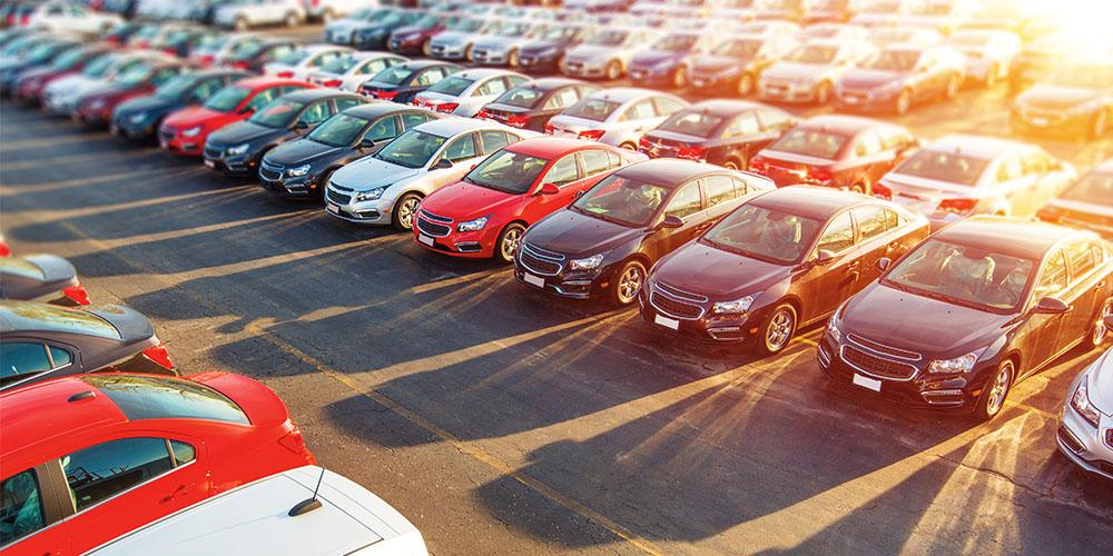 A lot of cars parked in a parking lot.